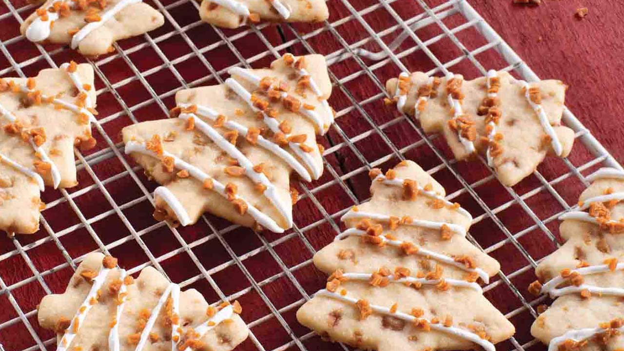 batch of skor toffee sugar cookie cut outs cooling on wire rack