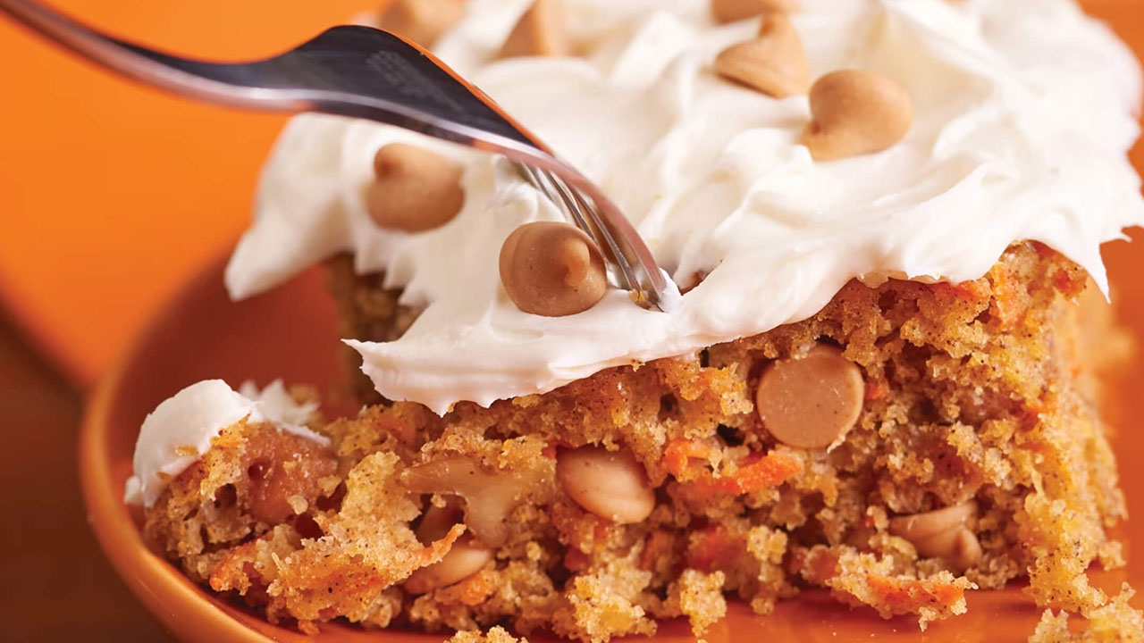 fork going into easy mouthwatering carrot cake filled with reeses peanut butter chips