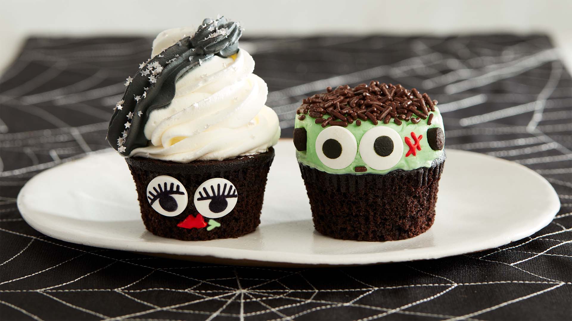 plate of fully decorated halloween monster cupcakes