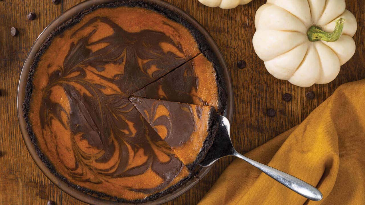 Servir une tranche de tarte à la citrouille marbrée au chocolat avec des pépites Hershey's Chipits